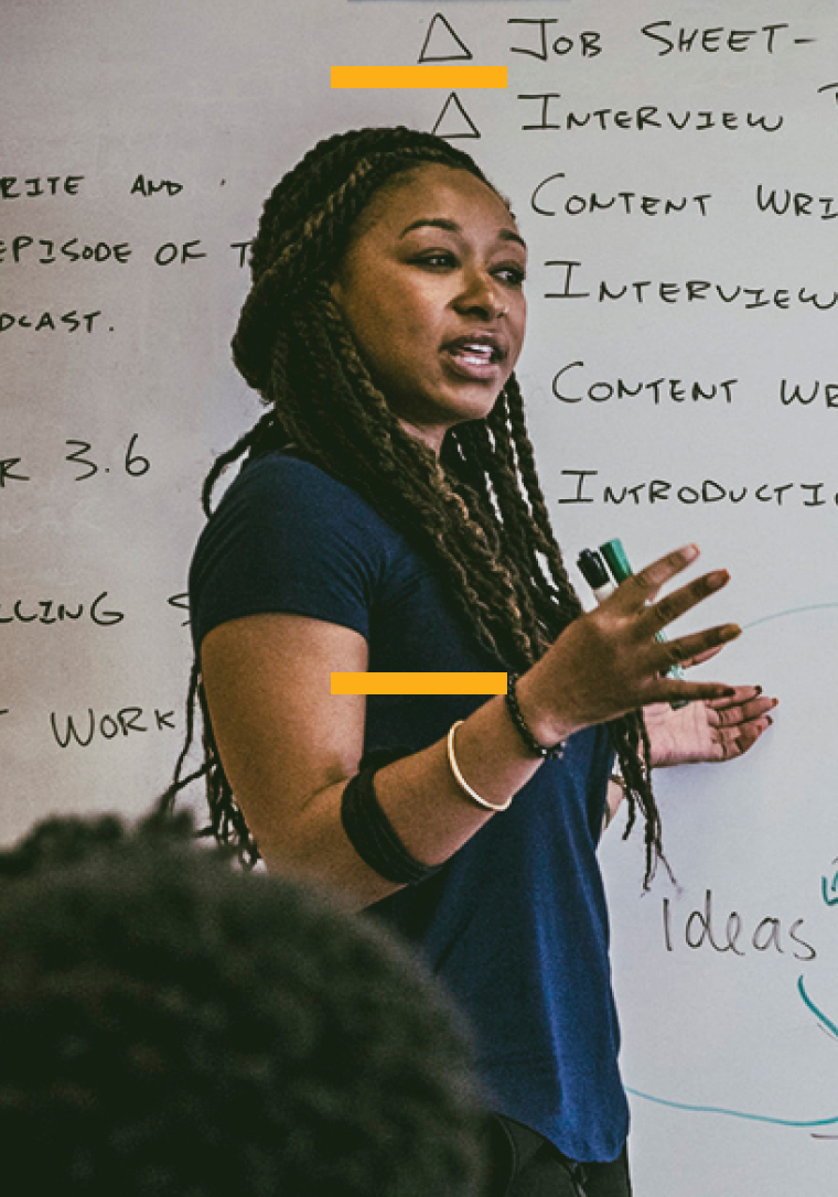 African American woman in front of whiteboard